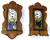 Two miniature W. Paul Holland carved front clocks. One wall, one standing. Signed on backs "Original No. 1" and "Original No. 2" along with maker name. Small spring wound pendulum movements. 13" tall.