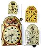 Four Black Forest shield front weight driven wall clocks. Brightly painted dials, wood plate movements, two have bells on top. Smallest with cute little painting of shepherds is 8" high. Largest, with bold columns and flowers, is 18" high.