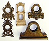 Five cast metal clock cases (no movements). Heavy and detailed castings including two novelties, large bronzed tambour and mini long case 14" tall.