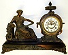 New Haven "Clotho" cast metal 8 day figural mantel clock, c1900.