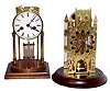 Two modern German 8 day striking clocks with brass movements on wood bases under round glass domes, 12" high.