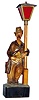 German carved and painted whistler leaning on lamppost with mechanical movement and battery powered lamp, c1930