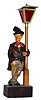 German carved and painted whistler leaning on lamppost with mechanical movement and battery powered lamp, c1930