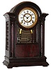 F. Kroeber Clock Co., New York mantel clock with 8 day time and 6 bell strike spring driven movement in mahogany case with beveled glass and white enamel dial, c1898