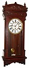 Waterbury Clock Co., Waterbury, Conn., "Cairo" wall clock 8 day time only spring driven movement in mahogany case with painted metal dial, c1914