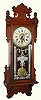 Gilbert Clock Co., Winsted, Conn., "Thespian" wall clock 8 day time and calendar spring driven movement in oak case with paper over metal dial, c1910