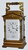 French, Brass Cased Carriage Clock, in an architectural case with Corinthian columns and a pediment top with original silvered platform visible through rectangular lens at top. This is a time, strike, repeat and alarm carriage clock, c1900