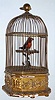 French or Swiss, a large singing bird in cage, with a gilt wood and gesso base, brass cage, controls and winding from the base, C.1880