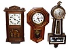 Three wood case 8 day time and strike wall clocks.