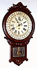 William L. Gilbert Clock Co., "Office Drop Calendar" 8-day with Maranville type rotating disc simple calendar with month and days of the week, in a walnut case with carved trim and burled walnut veneer accents. Note Gilbert used paper discs, moved by a pointer to evade the Maranville patent. c.1881