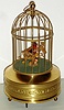 Singing bird single German mechanical with tail and beak motion when singing in gilt cage, c1930