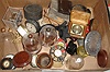 Large box lot of travel clocks, watch display stands, a cast iron watch hutch, figures, movements, movement brackets, navigational watch holder, mainsprings, etc.
