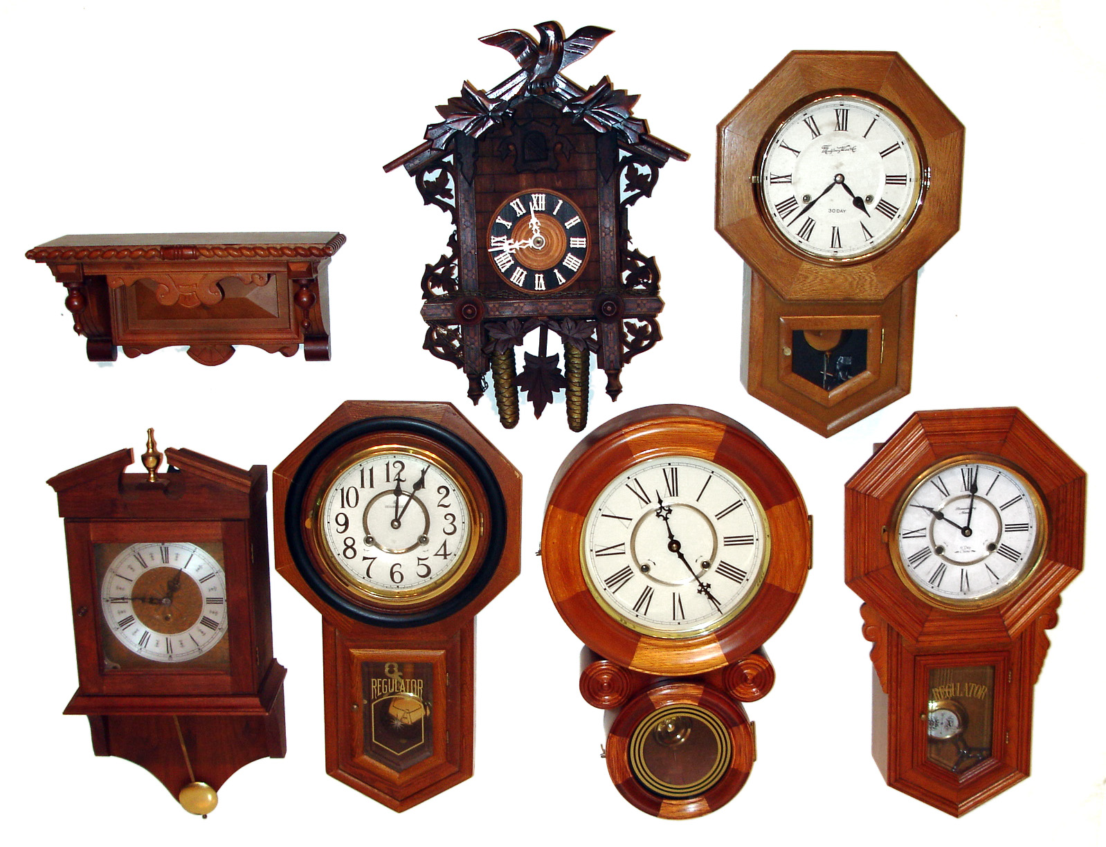 Clocks- 6 (Six) wall clocks: modern Asian wood reproductions including three schoolhouse, a mosaic ionic, and a two weight cuckoo. All except one are strikers. A wall mount shelf for gingerbreads completes the lot — Antique Clocks Price Guide