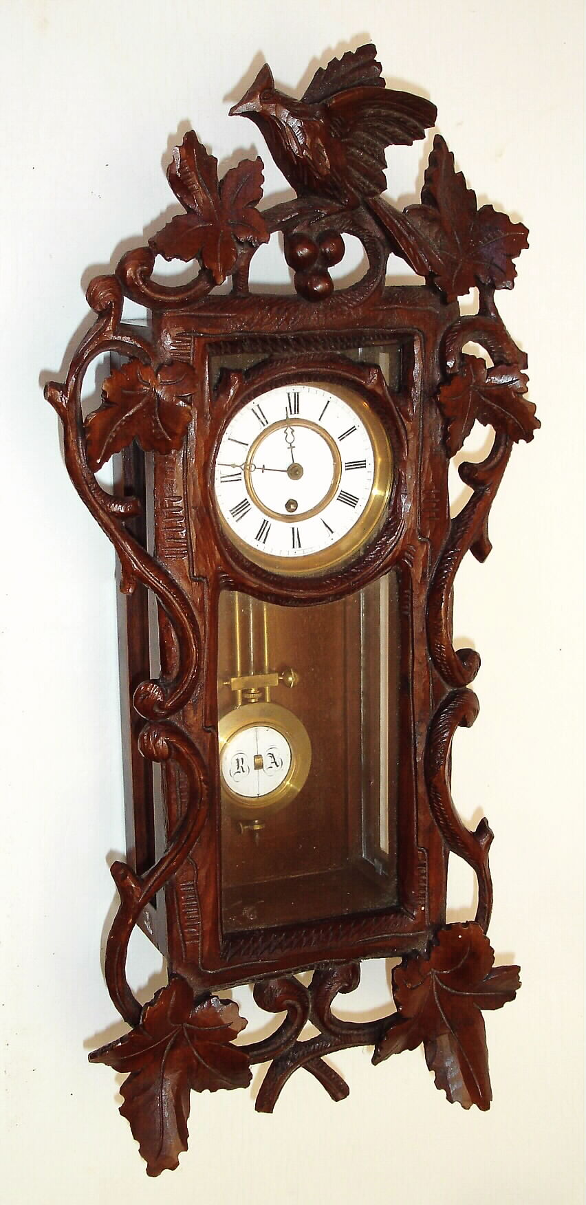 German, miniature "RA" wall clock in a "Bird and 7-leaf with Cuckoo" format, the door surrounded with vines, and the small spring movement with 7 wheels in the train to achieve 8 day duration, c1880 — Antique Clocks Price Guide