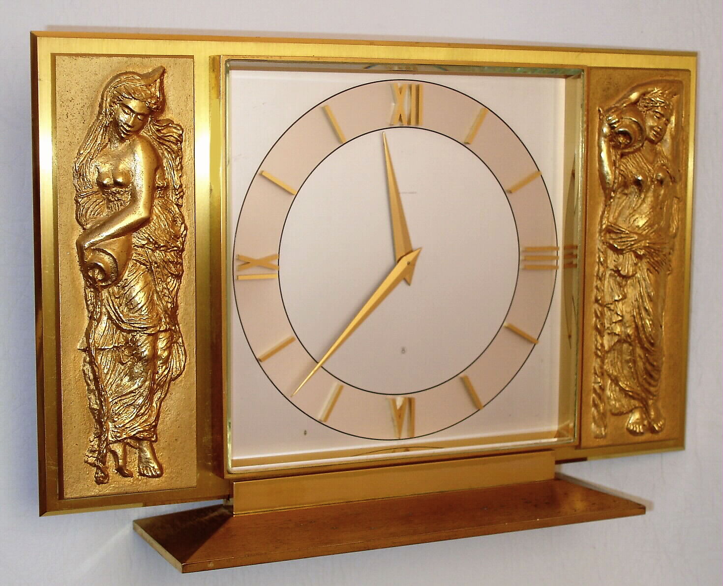 Swiss, for "Saks Fifth Avenue", ormolu desk clock in Art Nouveau motif, with a different lady emptying her water jug on each side of the dial. 8 day time and strike, c1950 — Antique Clocks Price Guide