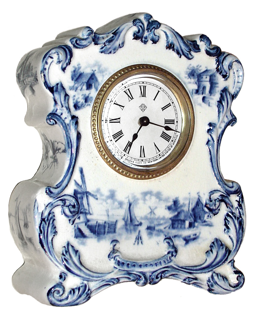 Ansonia Clock Co., 30 hour, lever movement timepiece in a delft style porcelain case. It could be a Royal Bonn case, but it is not marked, c1900 — Antique Clocks Price Guide