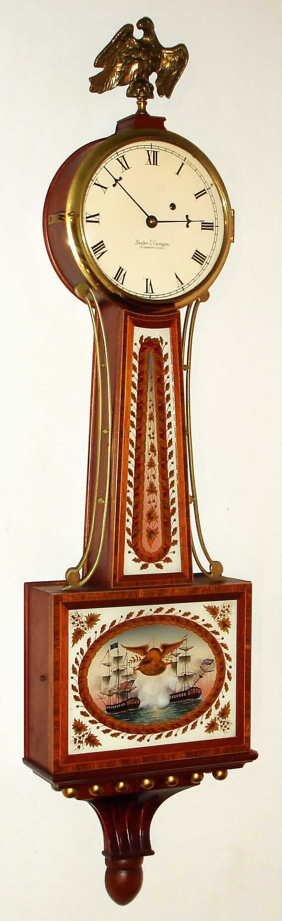Foster Campos, Pembroke, Mass, "Patent or Banjo" time piece with 8 day, weight driven movement in banded and inlaid mahogany case with reverse painted tablets, signed on the movement, case, dial and weight. Dated number 10 of the year 1985. — Antique Clocks Price Guide