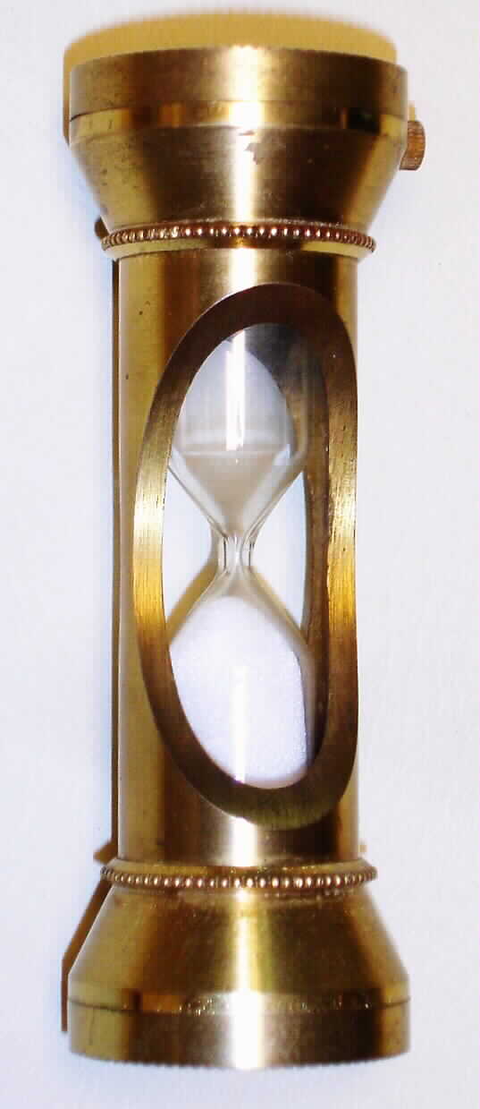 Sicura, Swiss gilt desk clock and hour glass combination with 23J, spring driven movement and metal dial with date at 3 inset into top of hour glass. The bottom of glass is inset with a gilt horse's head, c1965 — Antique Clocks Price Guide