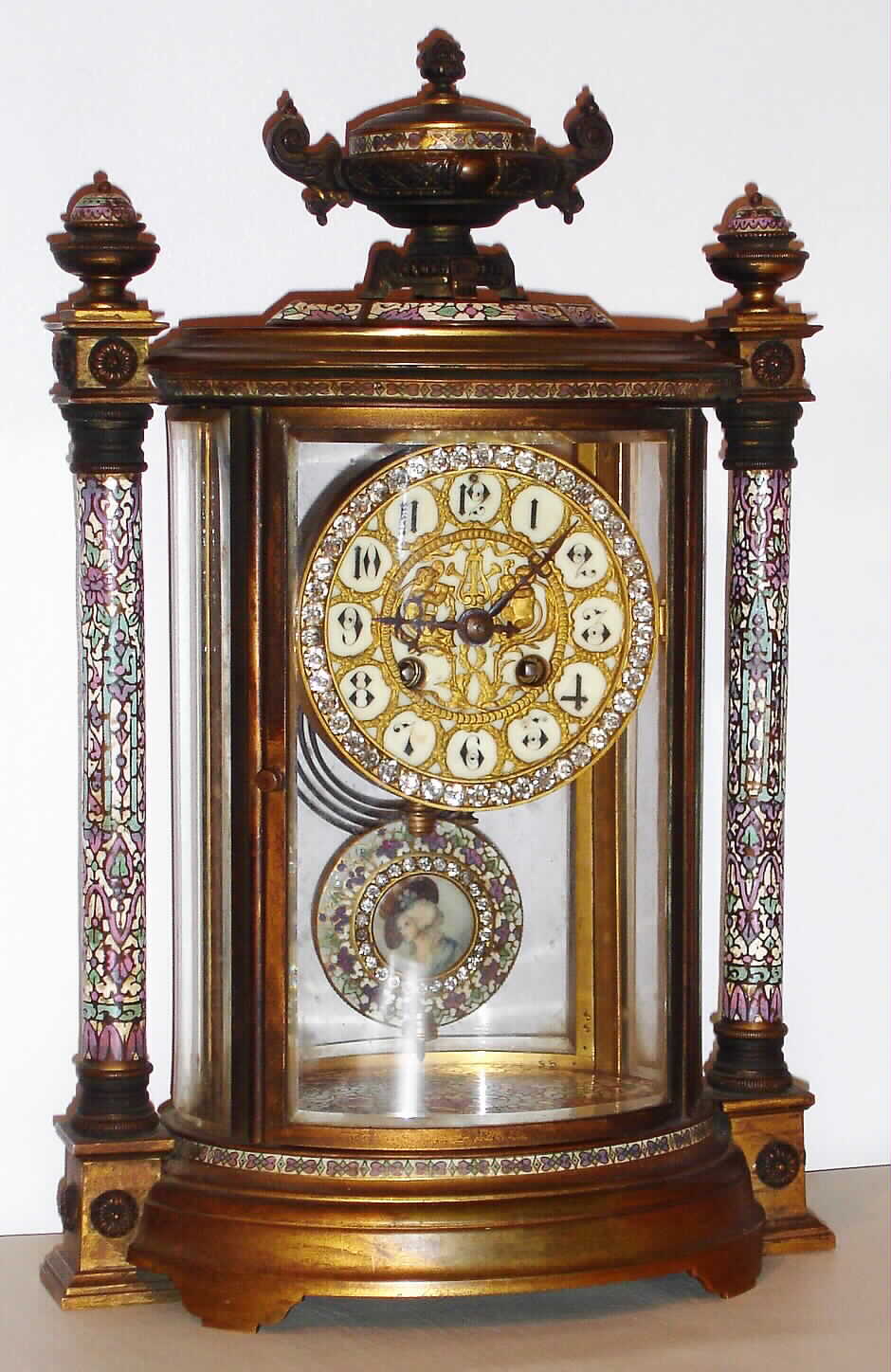 French oval crystal regulator mantel clock, 8 day, time and strike, spring driven movement in brass and multicolor enamel case with bejeweled pendulum inset with artist signed portrait of an aristocratic woman and bejeweled dial surround, c1890 — Antique Clocks Price Guide