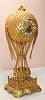 French, Large Cast and gilt bronze Balloon Clock, the case depicting a hot air balloon with a woven basket below, and is anchored to the ground within a fenced platform. Has a gold dore finish. Dial has applied Arabic numerals and fancy black hands; typical round French brass time and strike movement, signed Japy Freres, c1890