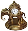 French, gilt bronze and brass figural timepiece in the form of an elephant carrying a sedan on his back, run by a lever escapement watch movement.