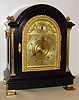 Tiffany and Co., New York bracket clock, 8 day, time, strike and Westminster chime, spring driven movement in an ebonized oak case with gilded cast door frame and beveled glass. The brass dial is marked "TIFFANY and CO. MAKERS" and has a silvered chapter ring and applied brass spandrels and cherubs, c1890