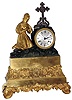 French gilded, 8 day, time and strike, silk suspension figural mantel clock with a figure praying next to a cross. Name found on the dial reads: "Taupin A Romorantin", c1840