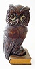 Oswald, German, "Wise Old Owl", rotating eye 30-hour timepiece, molded composition body on a carved wooden book base. c1930 .