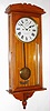 New Haven Clock Co., New Haven, Conn., "Vamoose" wall clock, 30 day, time only, double spring driven movement in grain painted oak case with painted metal dial, c1911