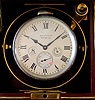 American Waltham Watch Co deck watch, 8 day duration with wind indicator 35S 15J, stem wind, pendant, set, adjusted, damascene nickel movement with lever escapement and Roman numeral silvered metal dial with subsidiary seconds at 6 and an inset "8 DAYS" emblem all housed in brass case with base metal coin edge bezel set on gimbals in a mahogany box with two metal tags reading "WALTHAM", s#22228667