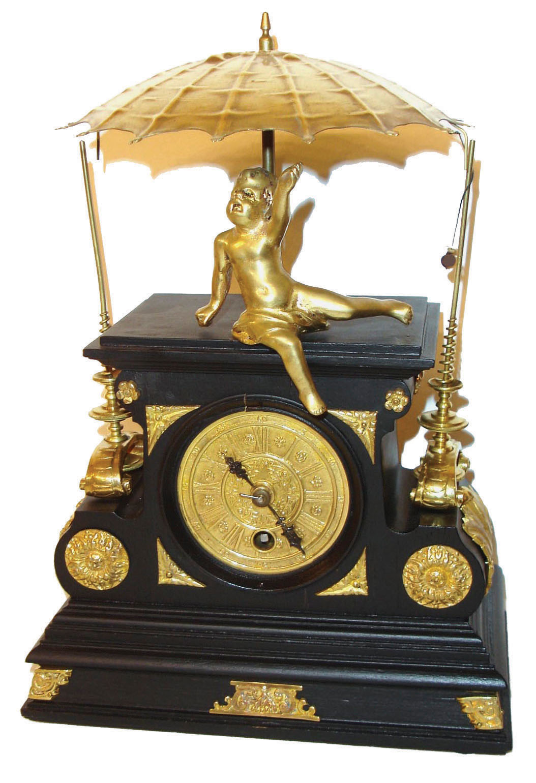 European version of the "flying pendulum" clock.  This is an interesting clock, in that an odd movement has been converted to power a center shaft which flails the flying pendulum from post to post, while the time portion of the movement is regulated by a short pivoted pendulum with adjustable bob. — Antique Clocks Price Guide