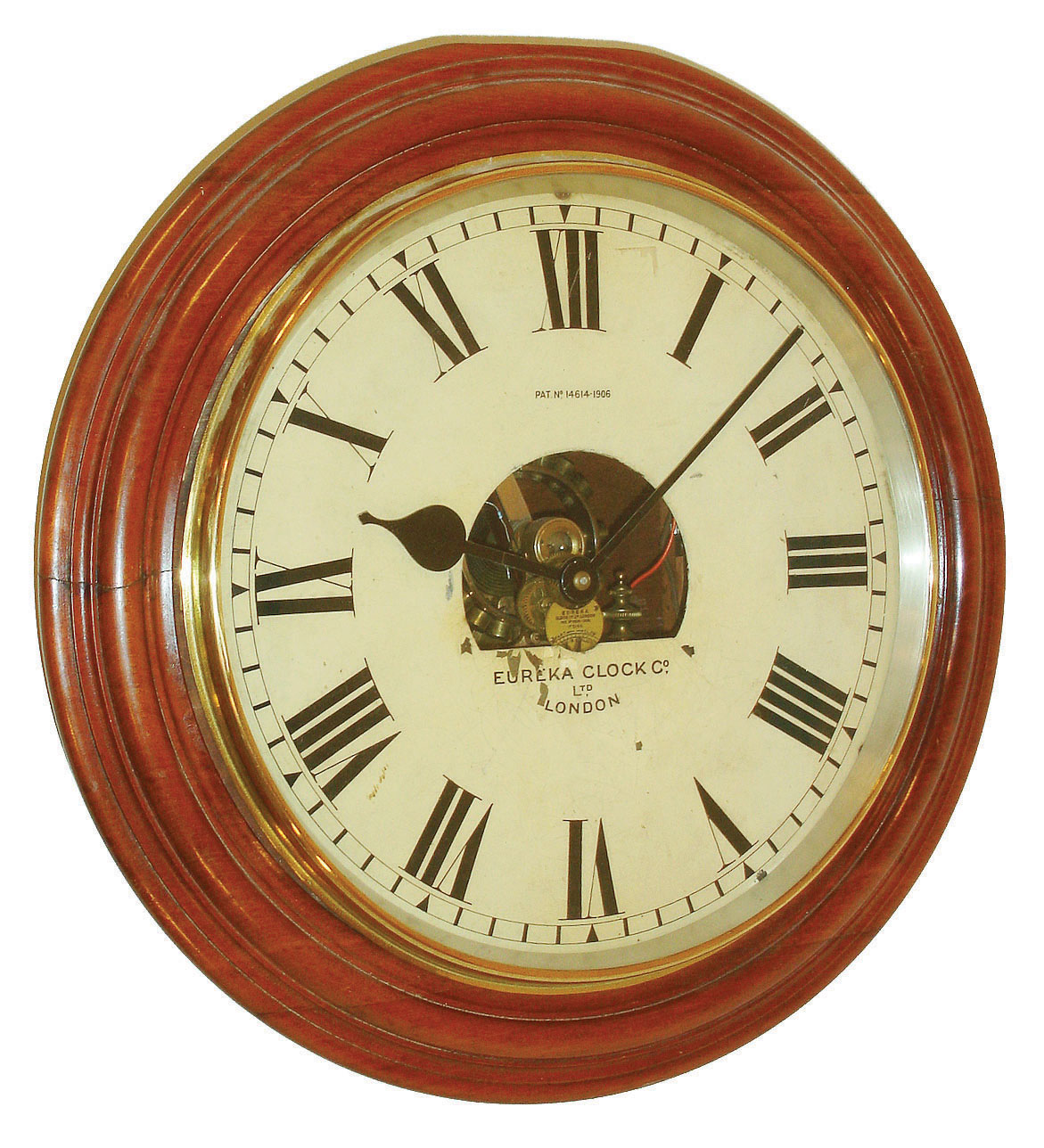 Eureka Clock Co., London, gallery clock, turned mahogany front mounted to a dovetailed mahogany case with battery compartment at lower right, brass bezel, Roman numeral white painted metal dial, black painted steel hands, dial center with cutout revealing the Eureka electric movement with large balance wheel, serial #5144, c1910 — Antique Clocks Price Guide