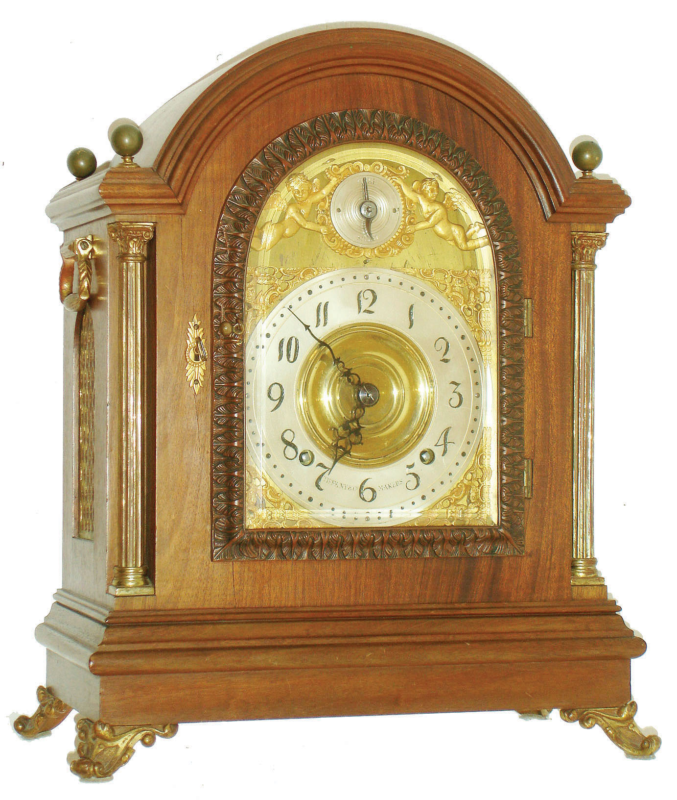 Tiffany &amp; Co. Makers, New York, large mahogany bracket clock with quarter striking, mahogany case with cast brass scroll feet, brass Corinthian columns flanking the arched, cast brass door with acanthus leaf decoration and thick beveled glass, each side with fabric lined brass fret and heavy cast carrying handles, the four corners of the top with spherical brass finials, case back with mahogany door and fabric lined screen, thick brass composite dial with gilt spandrels, Arabic numeral silvered dial marked "Tiffany &amp; Co. Makers", dial arch with gilt putti flanking silvered Strike/ Silent indicator, pierced steel hands, very substantial brass movement with Brocot escapement, back plate  marked "Tiffany &amp; Co. Makers Patented Nov. 7th 1882" and with the number 716, full Westminster chimes and hour striking on 5 gongs, original pendulum and key, c1890 — Antique Clocks Price Guide