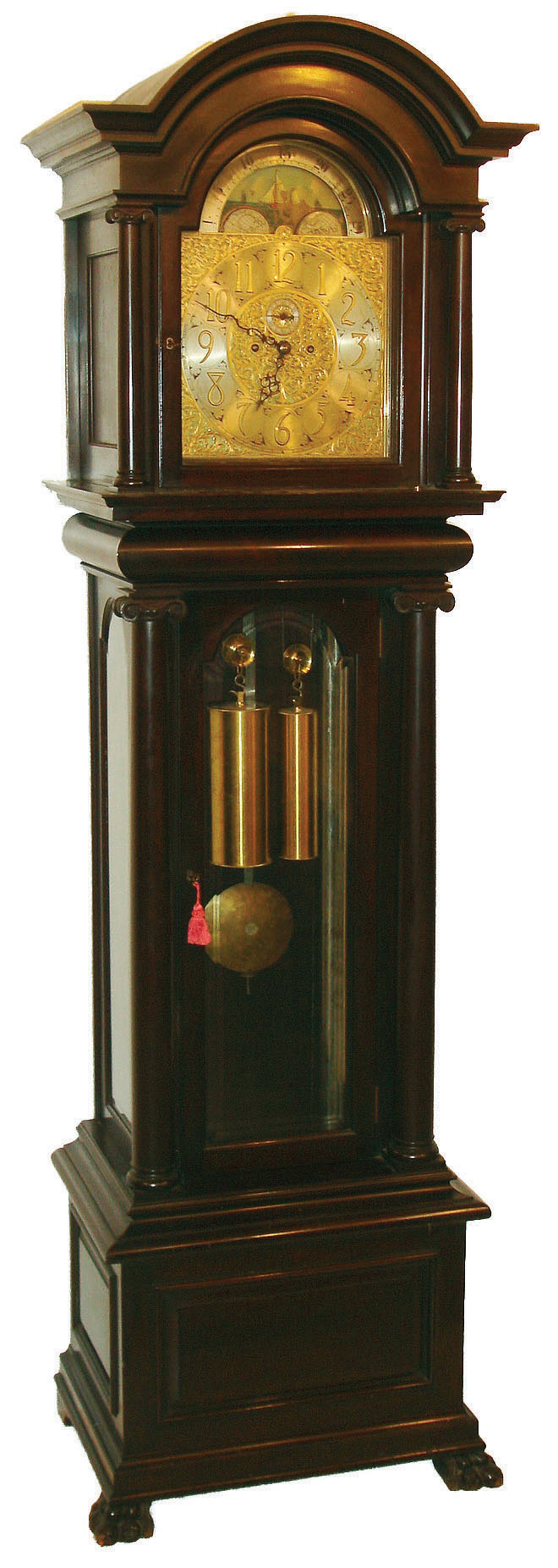 J.J. Elliot, London, England, tall clock, 8 days, time and strike on tube, weight driven movement in a mahogany case with paw feet, fully turned Corinthian columns flanking trunk door, beveled glasses and arch top with silvered chapter ring and moon phase in arch, brass numerals and heavy cutout fancy brass spandrels on corners and center, c1900 — Antique Clocks Price Guide
