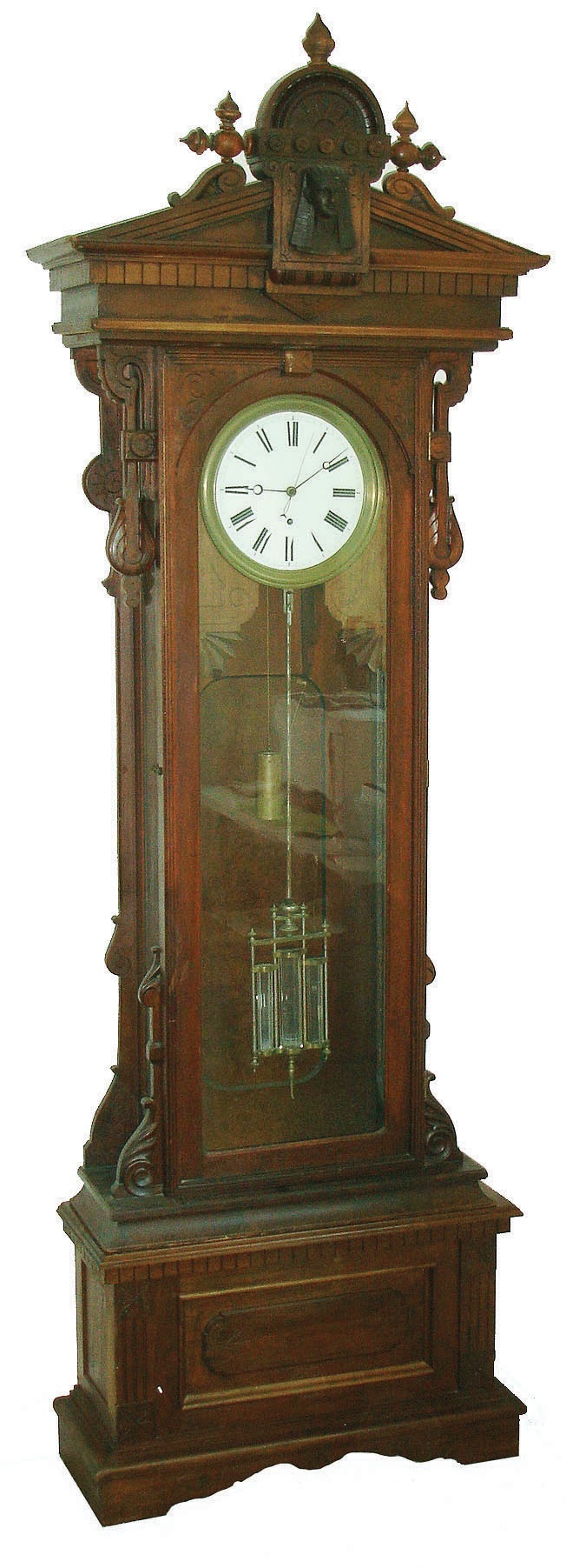 Wm. L. Gilbert Clock Co., Winsted Conn., "Regulator No. 16 Standing" floor clock, 8 days, time only, weight driven movement with pinwheel escapement, sweep seconds and three jar mercury pendulum in a walnut case with Egyptian head on pediment and white enamel dial, c1901 — Antique Clocks Price Guide