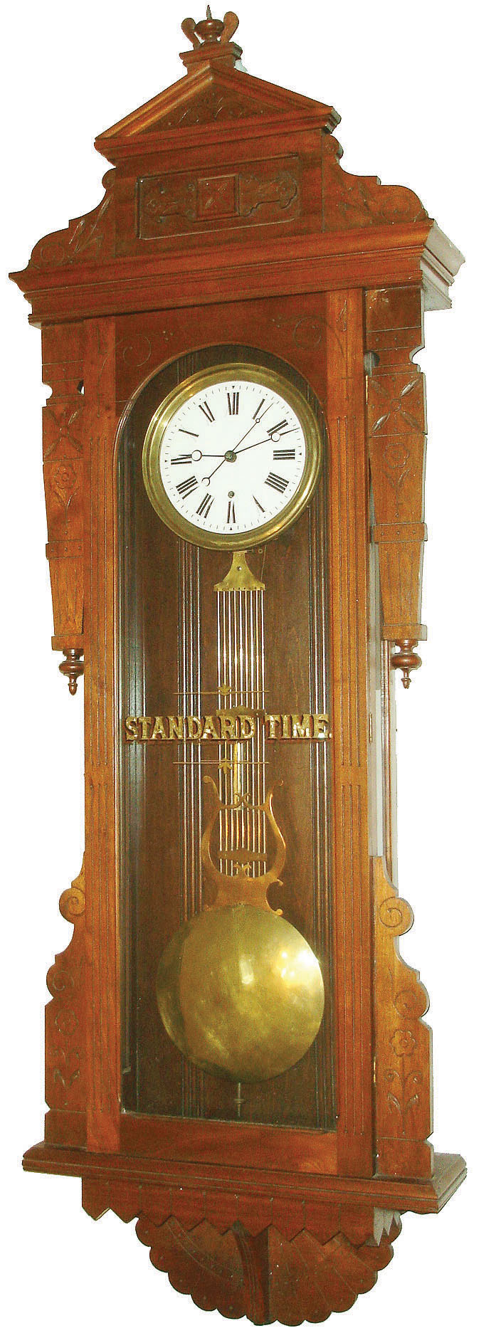 New Haven Clock Co., New Haven, Conn., "Regulator No. 9" wall clock, 8 days, time only, weight driven Swiss movement with gridiron pendulum, sweep seconds and a pinwheel escapement in a walnut case with white enamel dial and "STANDARD TIME" silk screened on glass, c1883 — Antique Clocks Price Guide