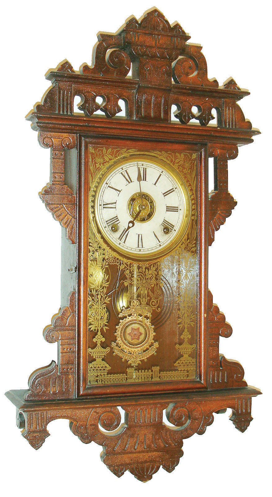 E. N. Welch Mfg. Co., Forestville, Conn., 8 day, time, strike and alarm hanging gingerbread clock. c.1885  Label states this clock was manufactured exclusively for: "Metropolitan Manufacturing Co.". — Antique Clocks Price Guide