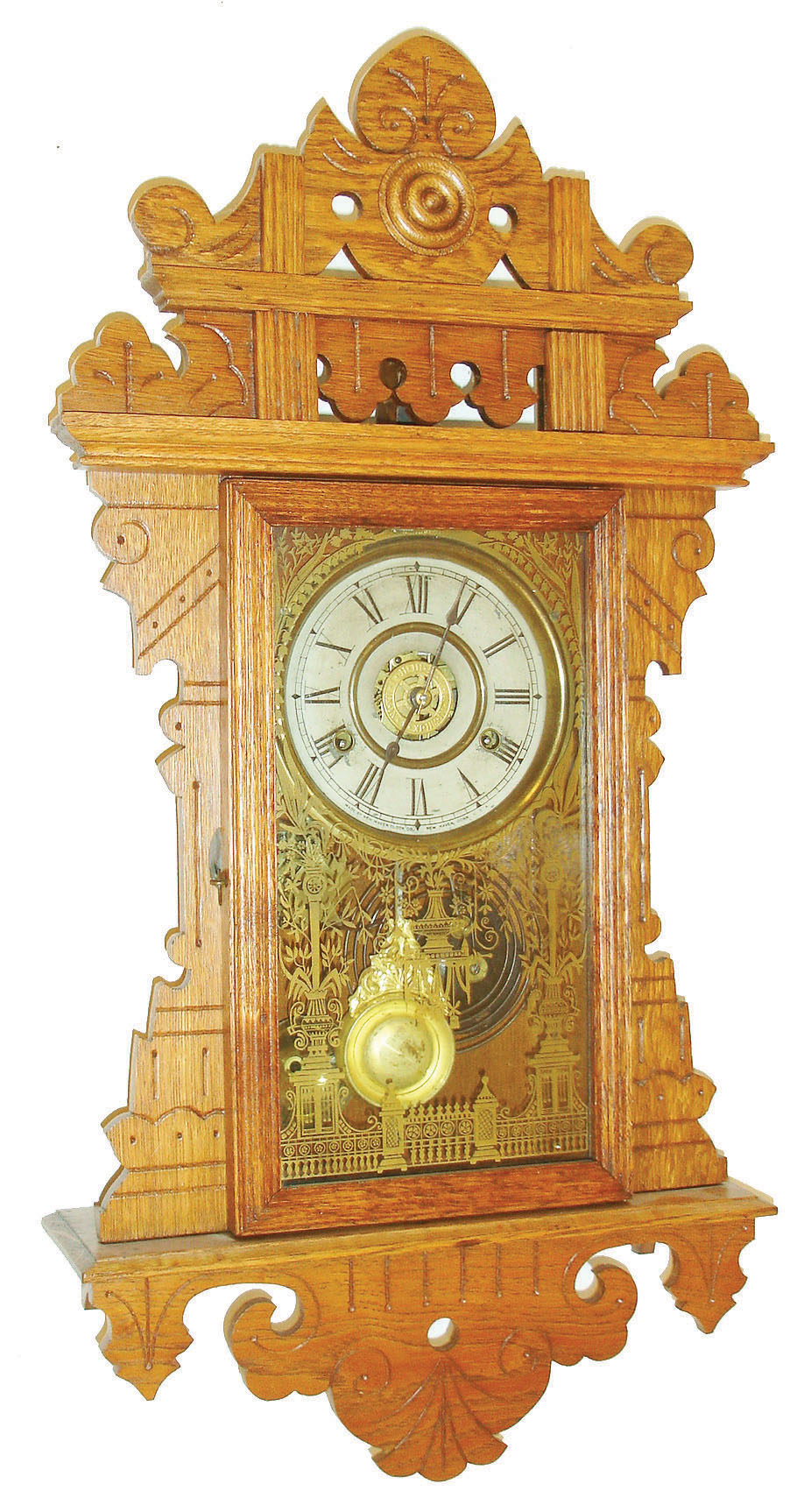 New Haven Clock Co., New Haven, Conn., "Eclipse " oak hanging gingerbread wall clock, 8 days, time and alarm, spring driven movement, American Wringer label, c1910 — Antique Clocks Price Guide