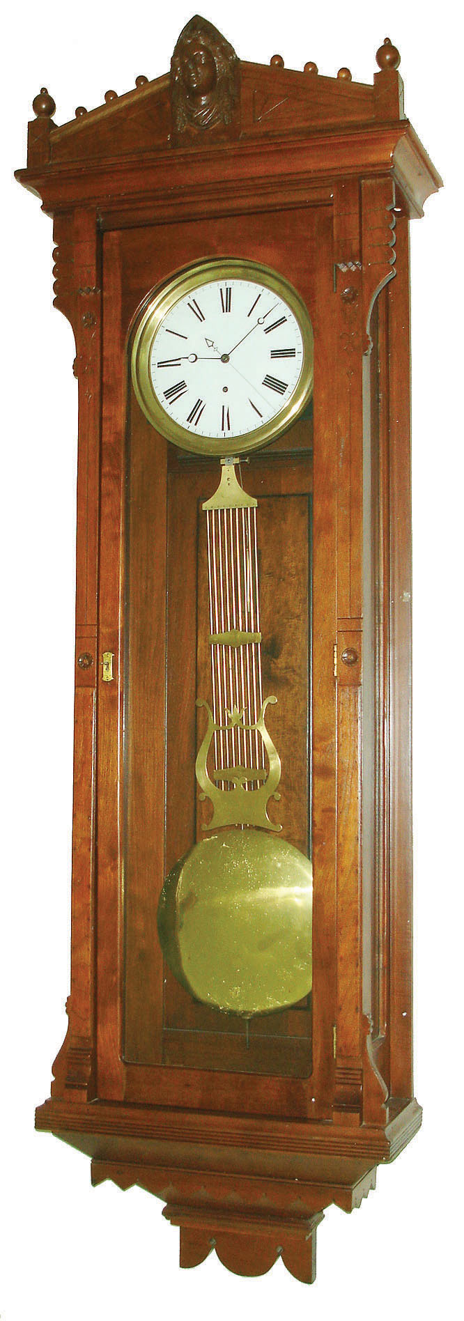 New Haven Clock Co., New Haven, Conn., "Regulator No. 2" wall clock, 8 days, time only, weight driven, Swiss movement with pinwheel escapement in a walnut case with Jenny Lind figure pediment top and white enamel dial, c1885 — Antique Clocks Price Guide