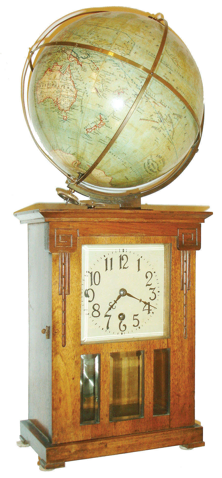 Junghans, Germany, Globe Clock, 8 day time only movement, rectangular walnut case in the arts and crafts style, the door with beveled glasses and simple carving, metal Arabic numeral dial, blued steel hands, the top with 10" terrestrial globe by Ludw. Jul. Heymann, Berlin, the globe geared to the movement and rotating once in 24 hours, c1910 — Antique Clocks Price Guide