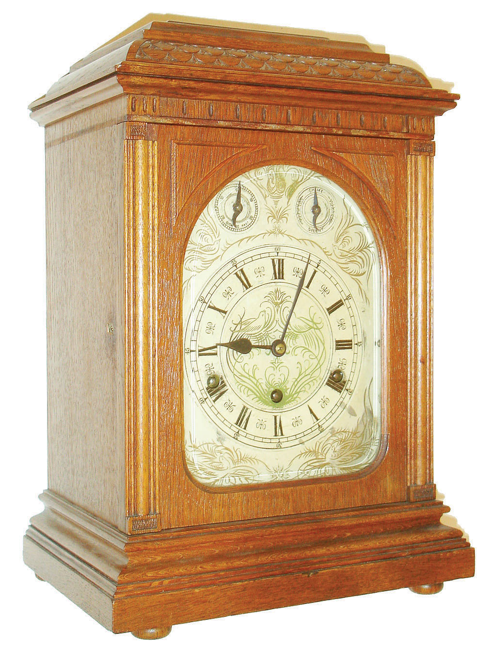 Lenzkirch, Germany, 3 train quarter striking bracket clock, oak case of architectural design, the door with thick beveled glass, back door pierced and with fabric lining, silvered dial with Roman numeral chapter ring, the corners and center decorated with calligraphic style birds and flourishes, blued steel hands, brass movement with Westminster chime and hour striking on five gongs, pull repeat activated by pulling cord at right side of case — Antique Clocks Price Guide