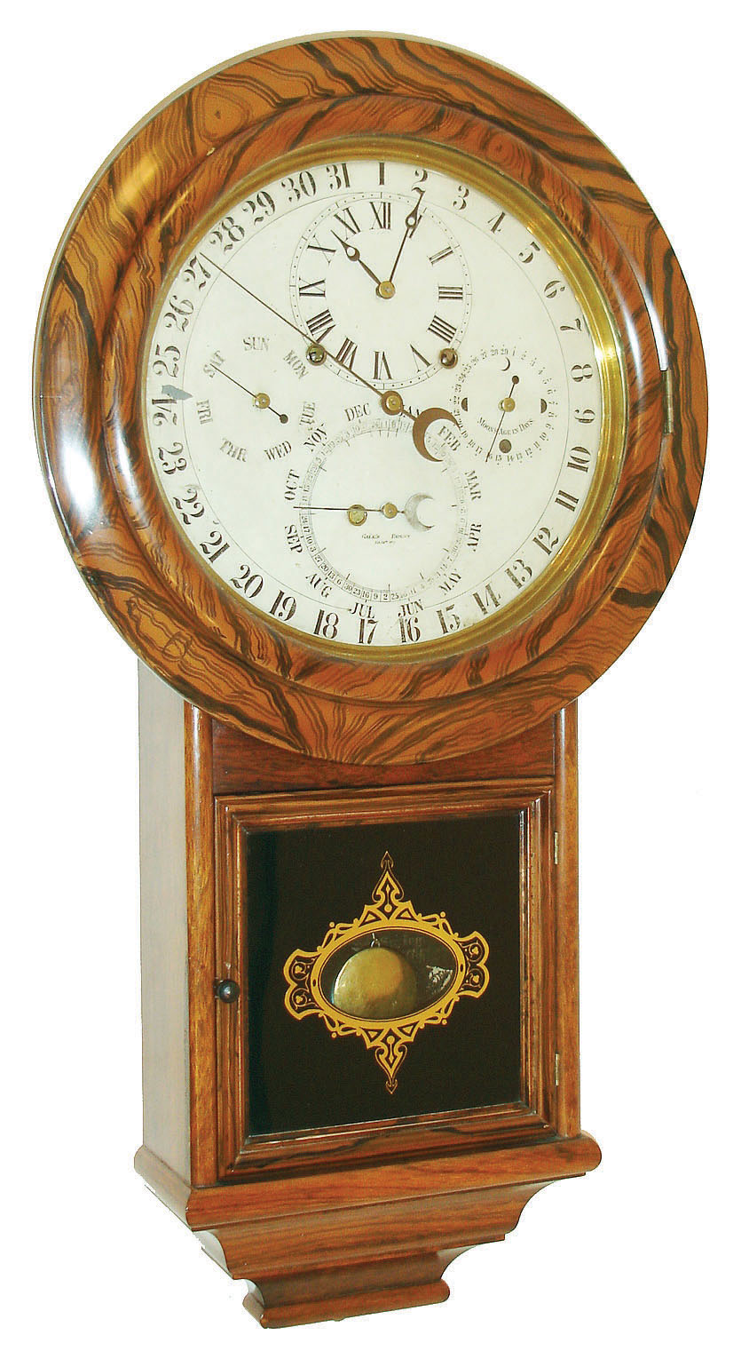 Welch, Spring &amp; Co., Forestville, Conn., "Gale Drop Calendar Model No. 1" wall clock, 8 days, time and strike, spring driven movement with perpetual calendar, patented 1869 and produced from 1871 to 1874.  The movement is housed in a rosewood veneer case with faux rosewood graining around top and a reverse painted lower tablet.  The painted metal dial is marked "GALES PATENT Feb. 14th, 1871", c1871. — Antique Clocks Price Guide