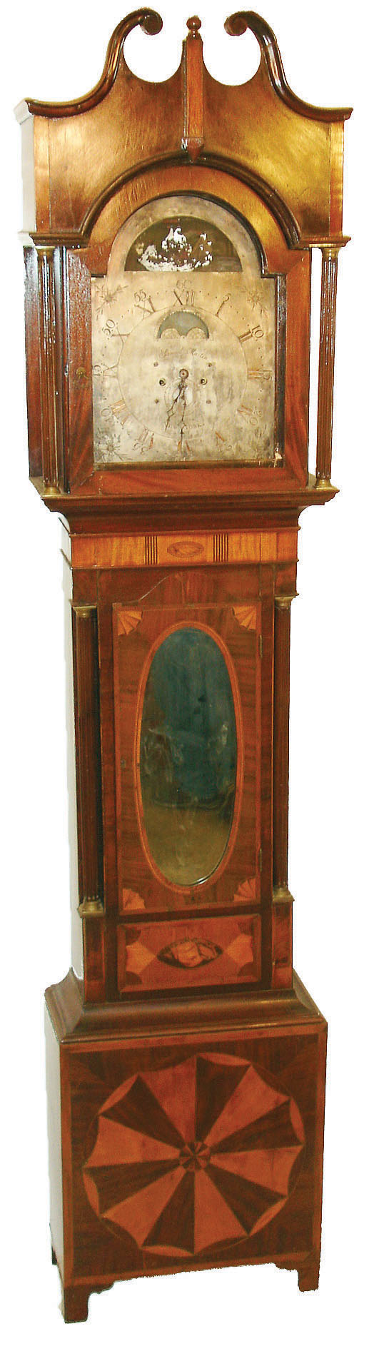 Samuel Martin, New York, NY, tall clock, 8 days, time, strike and calendar, weight driven movement with three separate hammers striking the quarter hours with varied sequence while the typical hour hammer strikes separately in an inlaid and marquetry mahogany case with conch shells, fans, scallops and broken arch top and a silvered sheet brass dial with moon phase and rocking ship, c1805 — Antique Clocks Price Guide