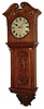 English carved wall clock, 8 days, time and strike, spring driven, double fusee movement in a well carved oak case with removable hood, full carved and reeded columns flanking carved trunk door, nicely carved North Wind base and painted iron dial, c1890