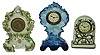 Clocks- 3 (Three) 30 hour time only porcelain novelty clocks:  German Delft style; Gilbert "Fayette" silver and white; Ansonia in German elaborate floral case; c1920