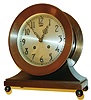 Chelsea Clock CO., Chelsea, Mass., "Commodore" model shelf clock, patinated bronze case with cavetto molded base on ball feet, 6" silvered dial with applied Arabic numerals, steel hands, marked "Chelsea Ships Bell", 8 day movement with ships bell striking, c1940