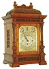Webster, Queen Victoria St., London, large bracket clock with chiming on choice of bells or gongs, oak case with carved panels featuring oak leaves and acorns at the base, frieze, and top, front door with thick beveled glass, flanked by carved pilasters with Corinthian capitals, molded cornice with egg and dart molding, the case top finished with two capped plinths with carved paterae and topped with finials, solid balustrade with central arch carved with a scallop shell and lateral foliage, case sides with pierced wooden fret with fabric backing, and back door with brass lattice fret with fabric backing, beautiful composite dial with silvered ground, gilt, pierced flowing acanthus dial mask with engraved detail, silvered applied chapter ring with gilt Arabic numerals, dial center engraved with acanthus and Aesthetic motifs, top of dial with strike/ silent indicator, regulation dial, and chime selector, pierced, blued steel hands, very heavy, unsigned, fusee movement, chiming the quarters on bells (Whittington) or gongs (Westminster), and with large gong for counting the hours, original key, c1880