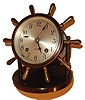 Chelsea Clock Co., Chelsea, Mass., "Vanderbilt" model table or desk clock, patinated brass case pivoting on supports mounted to the base, bezel with beveled glass, 4" silvered brass dial, blued steel hands, movement with ships bell striking, clock base engraved "Dave Bell In Memory of Many Happy Hours We've Shared, The Happy Hour", c1940