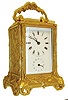 Grohe, Paris, carriage clock, gilt case with naturalistic ornament in the Art Nouveau style, beveled glasses at front and top, Roman numeral white enamel dial signed "Grohe Paris", blued steel trefoil hands, spade style alarm hand, signed 8 day brass time and alarm movement #5210, silvered lever platform, c1885