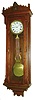 New Haven Clock Co., New Haven, Conn., "Regulator No. 2" wall clock, 8 days, time only, weight driven, Swiss movement with pinwheel escapement in a walnut case with Jenny Lind figure pediment top and white enamel dial, c1885